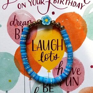 Blue and white mixed clay bead with gold spacers